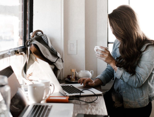 woman learns beginner tech skills in cafe